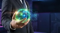 Businessman in dark suit holding glowing digital globe with green and gold light particles, representing global connectivity, technology innovation, and international business networks.