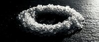 Young woman with fair complexion wearing a sparkling crystal bracelet on dark textured surface, luxury jewelry and accessories for fashion, beauty, and lifestyle design projects.