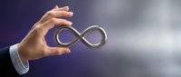 Hand holding infinity symbol representing endless possibilities, growth, and continuous improvement for business concepts.