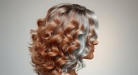 Woman with long wavy hair styled in copper and silver tones, shown in profile against neutral background for hair care and beauty product marketing.
