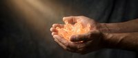 Cupped hands holding glowing warm light against dark background symbolizing hope, protection, care and spiritual guidance in dramatic lighting.