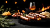 Grilled sausages on dark plate with sauerkraut, mustard and glass of whiskey. Atmospheric food photography with bokeh lights and pine branches.