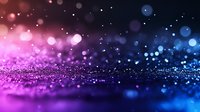 Magical glitter background with pink and blue bokeh lights creating dreamy atmosphere. Abstract defocused sparkles and particles for festive designs.
