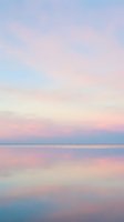 Serene coastal landscape at dawn with soft pastel pink, blue, and cream tones reflecting across calm water. Peaceful seascape for wellness, meditation, and relaxation projects.