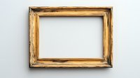 Empty vintage wooden picture frame with distressed golden finish and rustic edges mounted on white wall, ready for artwork or photo display.