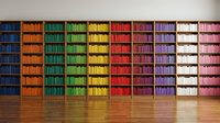 Colorful rainbow bookshelf with organized books arranged by color from blue to pink creating vibrant library wall display for education and reading concepts.