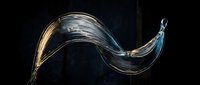 Flowing metallic ribbon with golden and silver streaks twisting against dark background, suitable for motion graphics, design overlays, and creative projects.