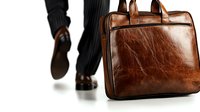 Brown leather business briefcase with walking businessman in dark suit and shoes on white background, isolated professional accessory for office use.