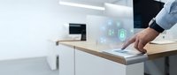Businessman using futuristic holographic interface technology on modern desk in contemporary office environment for digital innovation and smart workplace solutions.