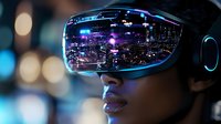 Young African American woman wearing virtual reality headset with city nightscape reflection, neon lights and urban skyline mirrored in VR goggles against dark background.
