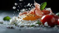 Fresh egg yolk with prosciutto ham, cherry tomatoes, cottage cheese crumbles and basil leaves on dark background with dramatic lighting and salt crystals.
