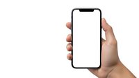 Hand holding modern smartphone with blank white screen isolated on white background for mobile app mockup and digital presentation.
