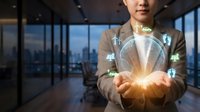 Asian businesswoman holding glowing green energy globe with eco icons, sustainable future concept in modern office with city view.