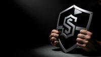 Hands holding transparent glass shield with dollar sign symbol representing financial protection and security against dark background.