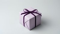 Purple gift box with satin ribbon bow on white background. Elegant present packaging for birthdays, holidays, celebrations and special occasions.