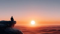 Person silhouette sitting on cliff edge watching golden sunrise over ocean horizon. Peaceful meditation moment with warm orange sky and calm waters.