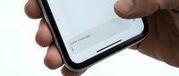 Male hands holding modern smartphone with white screen displaying enter password text field for mobile app login and security authentication.