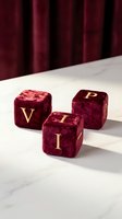 Luxury burgundy velvet dice with golden letters spelling VIP on marble surface against red curtain backdrop for exclusive entertainment concepts.