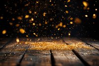 Magical golden glitter scattered on rustic wooden planks with floating bokeh particles against dark background, creating ethereal atmospheric effect.