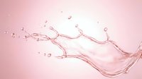 Pink water splash with droplets and dynamic motion on soft gradient background for beauty and skincare concepts.