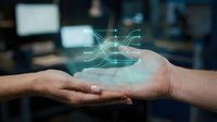 Hands exchanging digital network hologram representing data transfer, connectivity, and technology collaboration in modern business environment.