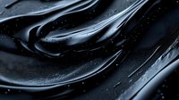 Glossy black liquid cosmetic texture with smooth flowing waves and droplets creates luxurious skincare product background for beauty industry advertising.