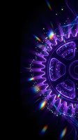 Purple neon gear mechanism with rainbow light effects and sparkles on dark background for technology and engineering concepts.