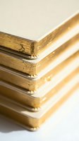 Stack of notebooks with luxurious gold gilded edges arranged in a pile, elegant stationery concept for branding, publishing, and premium design projects.