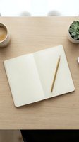Overhead view of open blank notebook with wooden pencil on light wood desk, coffee cup and succulent plant, workspace organization and creative planning concept.