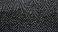 Dark gray herringbone fabric texture with detailed weave pattern for fashion design, upholstery projects, and textile backgrounds.