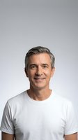 Confident middle-aged Caucasian man with gray hair smiling in white t-shirt on neutral background for business and lifestyle marketing materials.