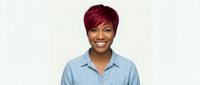 Smiling African American woman with short burgundy hair wearing light blue denim shirt on white background isolated for design projects and marketing materials.