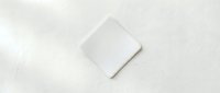 Minimalist white smartphone mockup on soft textured surface for branding and app presentation projects.