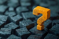 Orange question mark standing out among dark stone blocks, dramatic lighting creates contrast between bright symbol and textured background. Concept for FAQ and solutions.