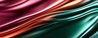 Luxurious smooth satin fabric waves in pink, copper and emerald green colors creating elegant abstract background with silky flowing texture and metallic shine.