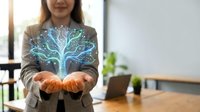Professional businesswoman presenting holographic digital tree with glowing branches symbolizing growth, innovation and sustainable technology solutions.