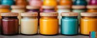 Colorful glass jars with wooden lids containing natural cosmetic products, creams, or food ingredients arranged in row showing vibrant yellow, turquoise and burgundy colors.
