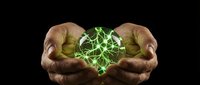 Hands cupping glowing green energy sphere with electric lightning effects on black background for technology and power concepts.