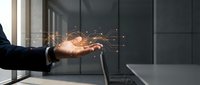 Businessman hand releasing glowing digital particles and light sparks from palm, representing data transfer, technology innovation, and wireless communication in modern office environment.