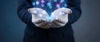 Business professional cupping hands with glowing hexagonal network pattern above palms representing digital connectivity and technological innovation.