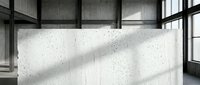 Modern concrete wall with natural light shadows in industrial loft interior space for contemporary architectural design and urban lifestyle concepts.