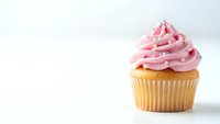 Single vanilla cupcake with pink buttercream frosting on white background. Sweet dessert for bakery menu, birthday party celebration or food blog content.