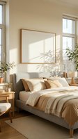 Bright Scandinavian bedroom with neutral beige tones, cozy bedding, wooden furniture, green plants, and blank frame mockup on sunlit wall.