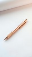 Rose gold metallic ballpoint pen with textured grip on white background, isolated and ready for product design, stationery mockups, and commercial use.