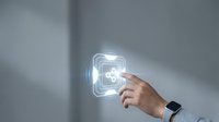 Person's hand with smartwatch touching glowing medical cross symbol on wall, representing healthcare technology, telemedicine services, digital health solutions, and medical app interface.
