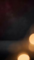 Dark moody background with warm golden bokeh lights in foreground, creating atmospheric depth. Blurred defocused circles suggest evening ambiance, suitable for overlays, backgrounds, and design projects.