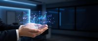 Businessman hand holding holographic financial data charts and graphs in modern office space for business analytics and market research presentations.