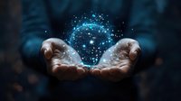 Magical glowing blue particles floating above cupped hands in dark background, creating mystical ethereal effect for spiritual and wellness concepts.