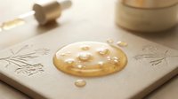 Freshly baked cookie with pearl sugar topping on neutral ceramic plate with decorative elements and gold accents, suitable for food styling and bakery marketing.