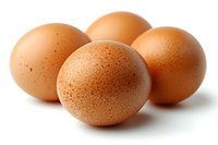 Fresh brown chicken eggs arranged on white background with soft shadows, showing natural speckled texture and organic appearance. Suitable for food concepts.